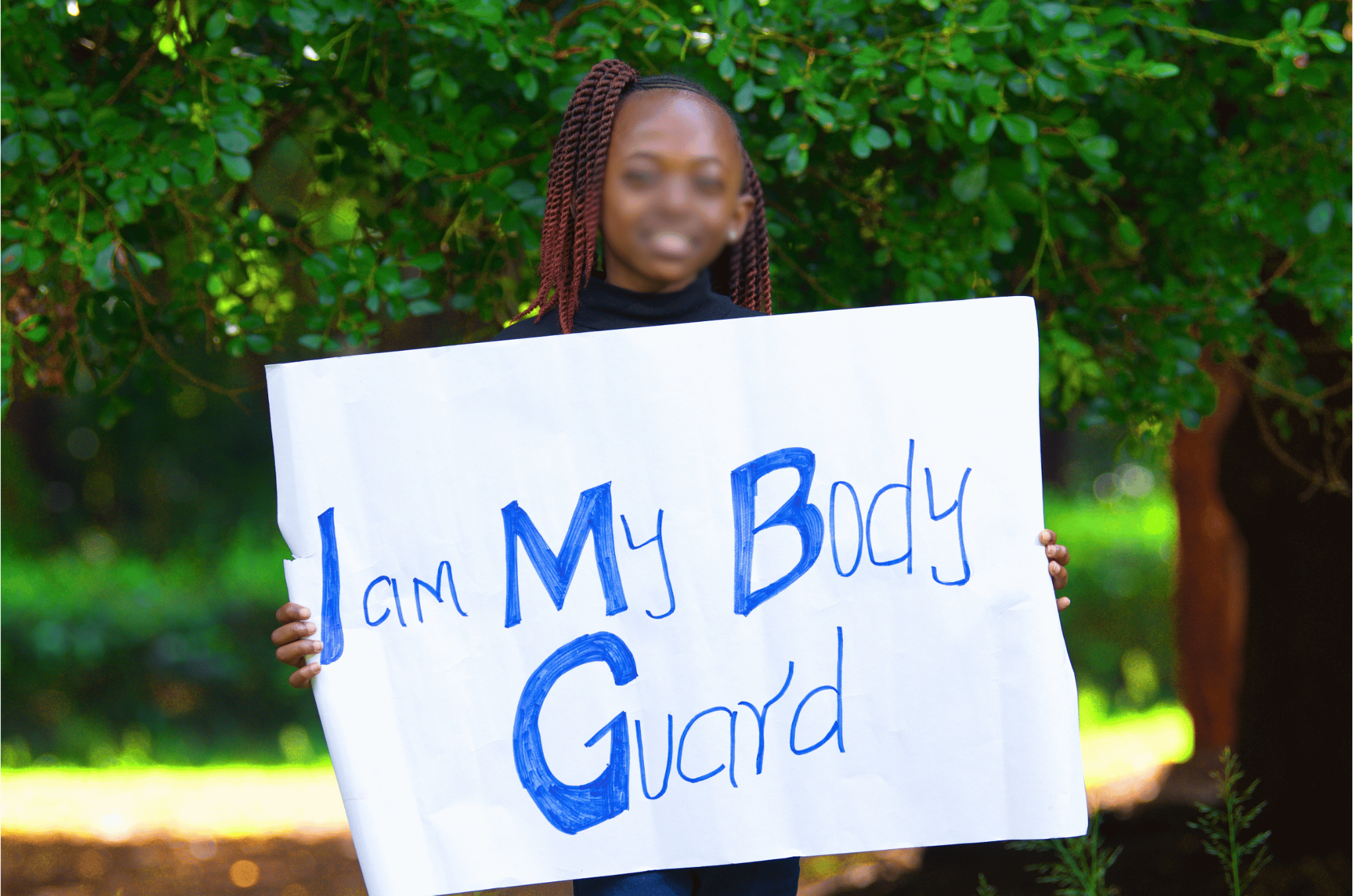 IAMB Girl Holding Sign Blurred Face (2) IAMB Girl Holding Sign Blurred Face (2)